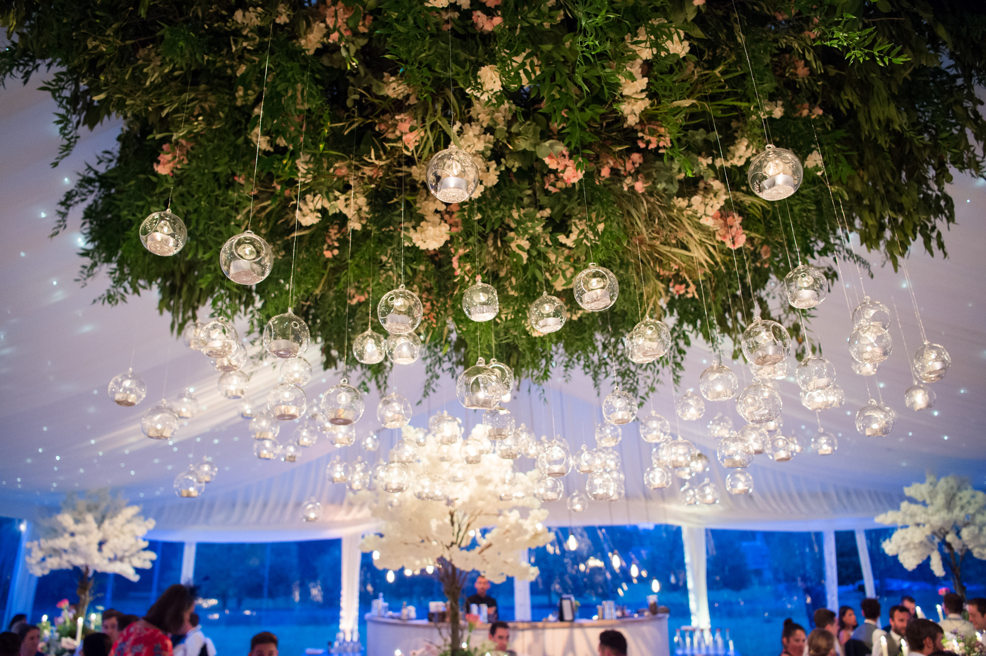 Wedding florals hanging from the ceiling by Copelands Flowers